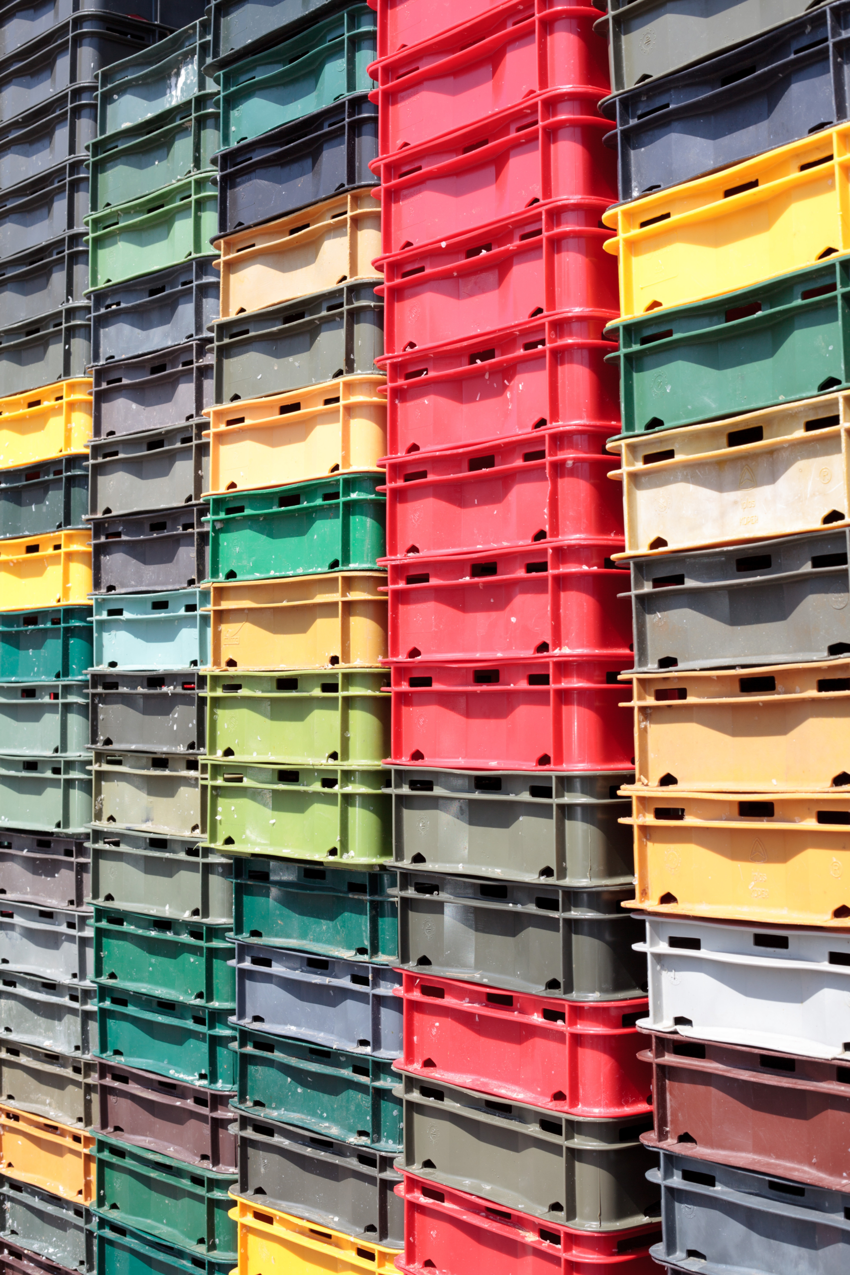 Stacked reusable plastic bakery trays supporting returnable packaging programs