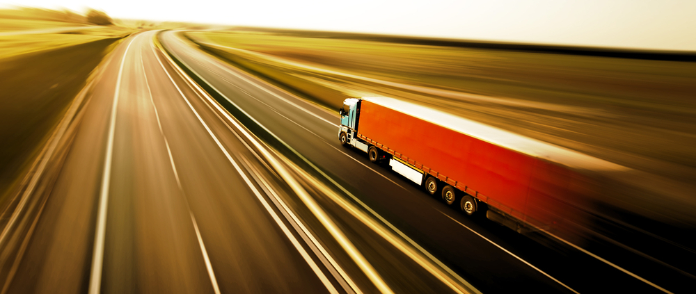 Truck on asphalt road motion blur
