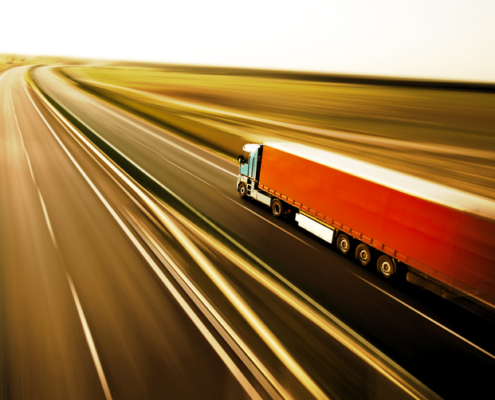 Truck on asphalt road motion blur